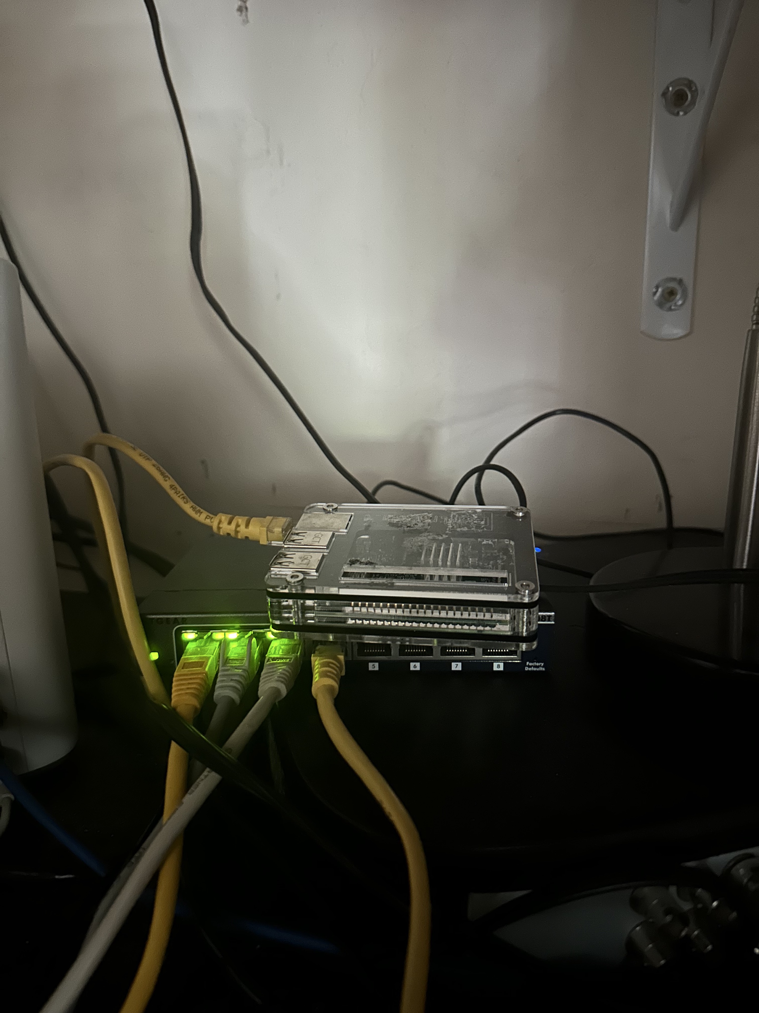 Raspberry Pi running Pi-hole beside network hardware